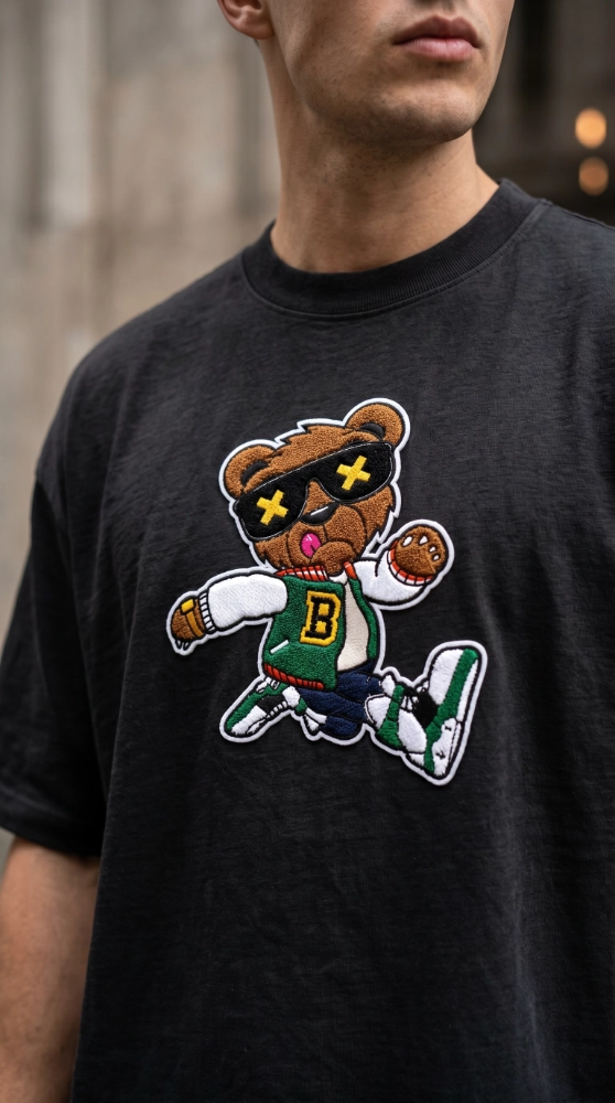 A black shirt features a vibrant Chenille patch of a bear in sunglasses, showcasing custom Chenille patches for clothes