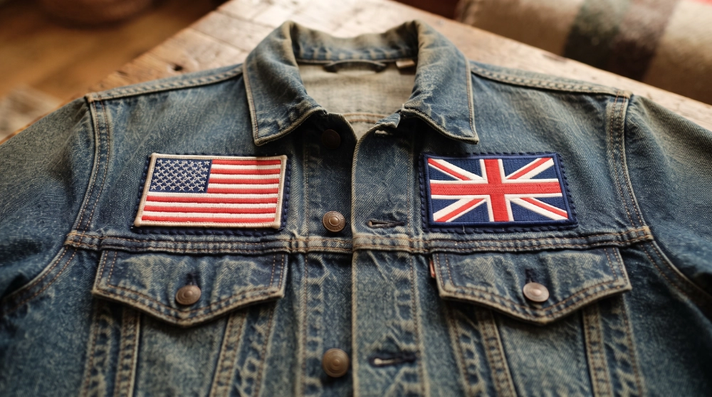 Denim jacket with two national flag patches stitched side by side representing dual heritage